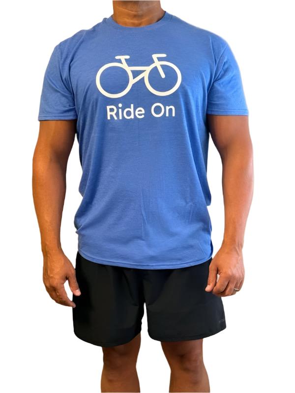 blue short sleeve t shirt with a white bicycle image on it with words saying ride on in white letters.